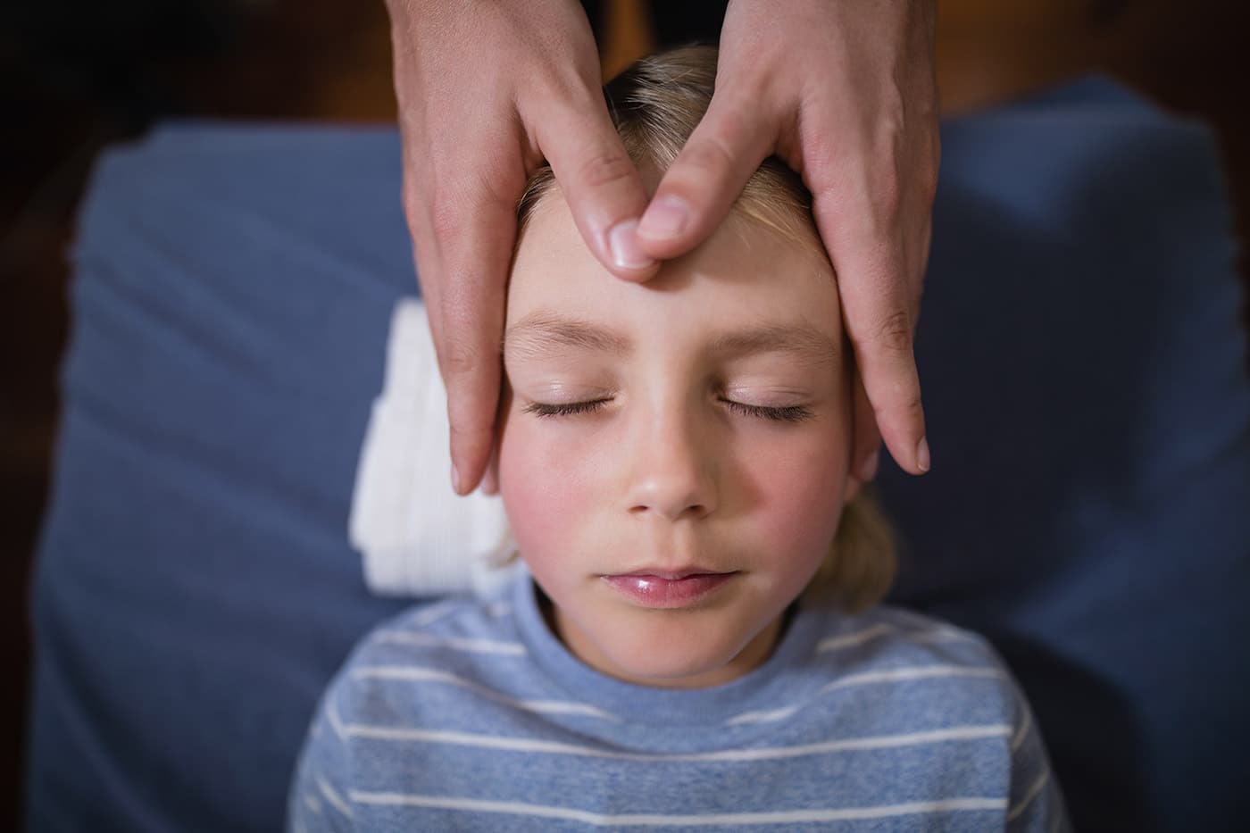 child receiving gentle touch on forehead for welln 2026 09 22 10 57 41 utc